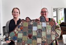 Sauvon koulukeskuksen ruokasaliin savireliefi Sauvon Käsien Erja-Riitta Alander ja Nina Messner esittelevät savireliefiä. Kuva: Julia Ojala, Sauvon kunnan viestintäharjoittelija.